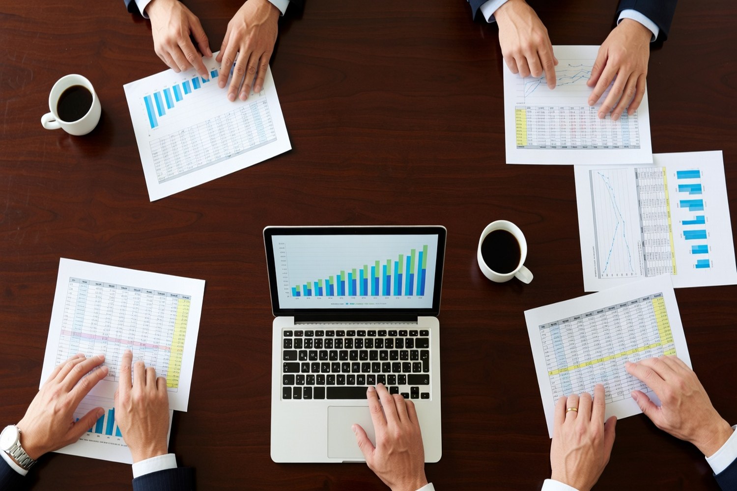 Business financial documents and charts representing 50K to 100K business loan rate comparison