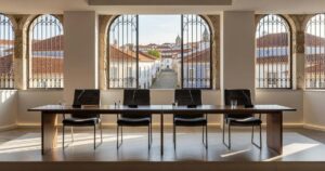 Empty international central banking panel stage with four microphones at a conference in a historic Portuguese hilltop town