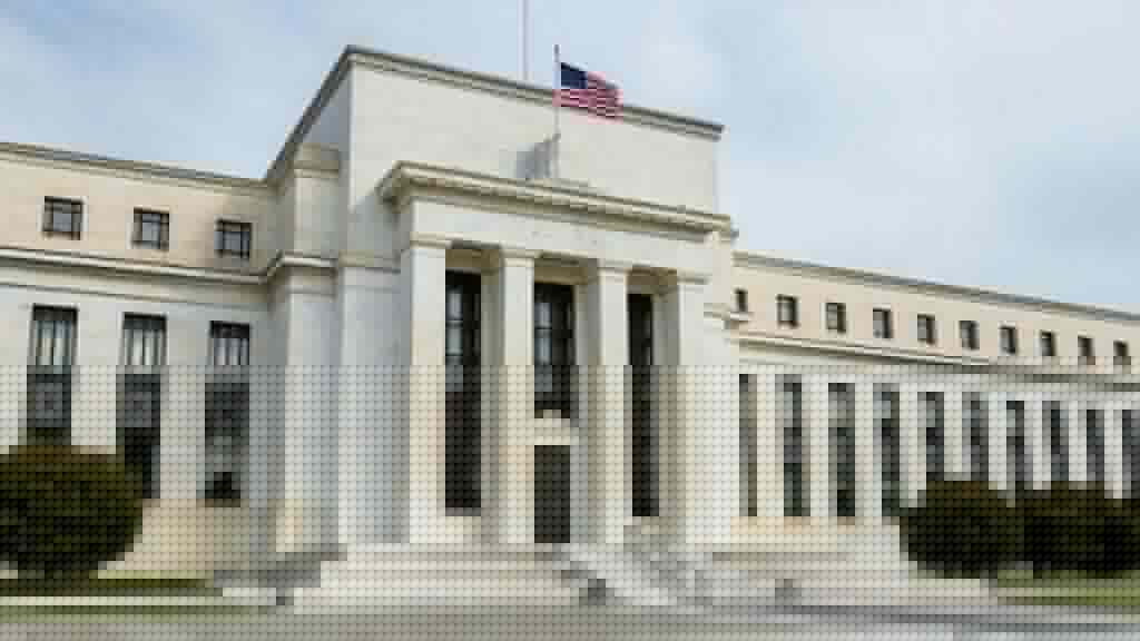 The Federal Reserve Marriner S. Eccles building facade in soft daylight with an American flag, ahead of an interest-rate policy decision.