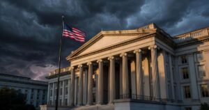 The United States Treasury building in Washington at dusk with golden light on its granite columns, an American flag in the foreground and dark storm clouds gathering overhead