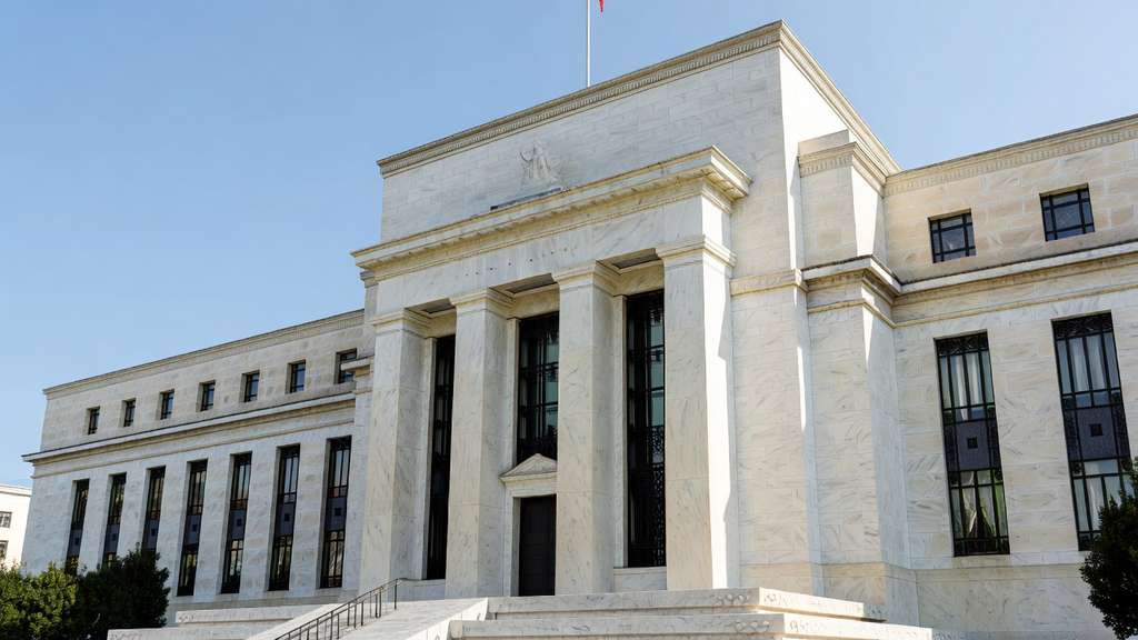 Exterior view of the U.S. Federal Reserve building with tall marble columns in daylight