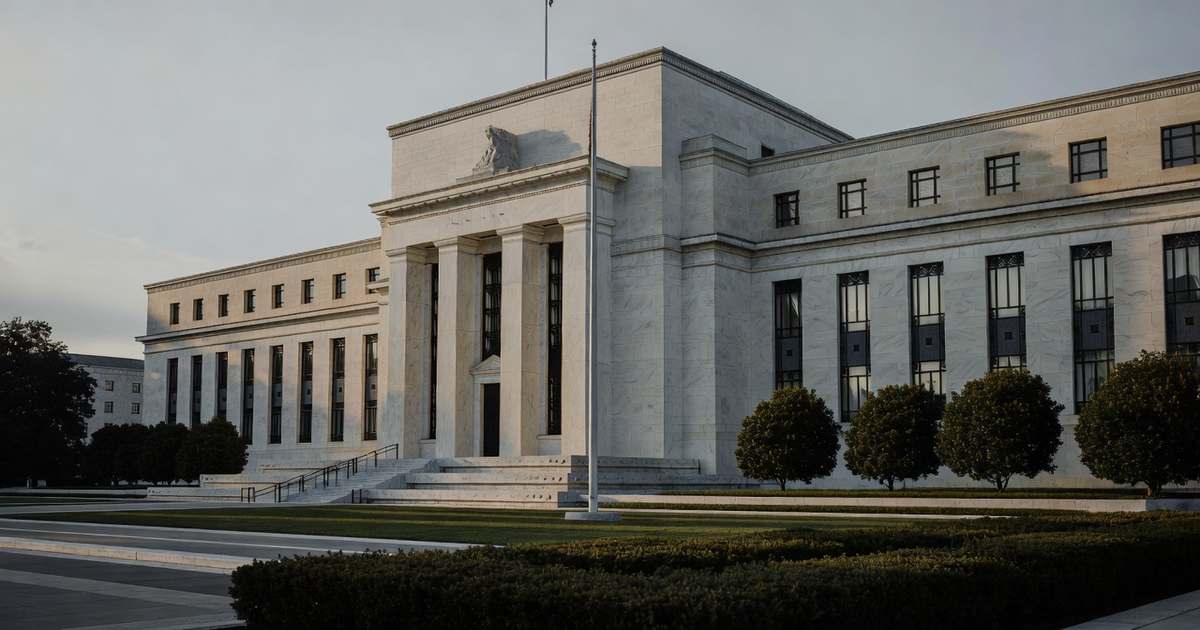 The neoclassical limestone facade of the Federal Reserve Marriner S. Eccles Building in Washington photographed at early morning with tall fluted columns deep window recesses raking dawn light across the stone long cool shadows falling on the empty plaza a bare flagpole and low trimmed hedges in the foreground beneath a pale overcast sky